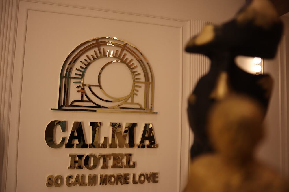 The CALMA Hotel brass emblem at the entrance